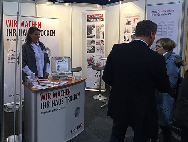 ISOTEC Messestand mit interessierten Besuchern und Informationen rund um das Thema Schimmel 